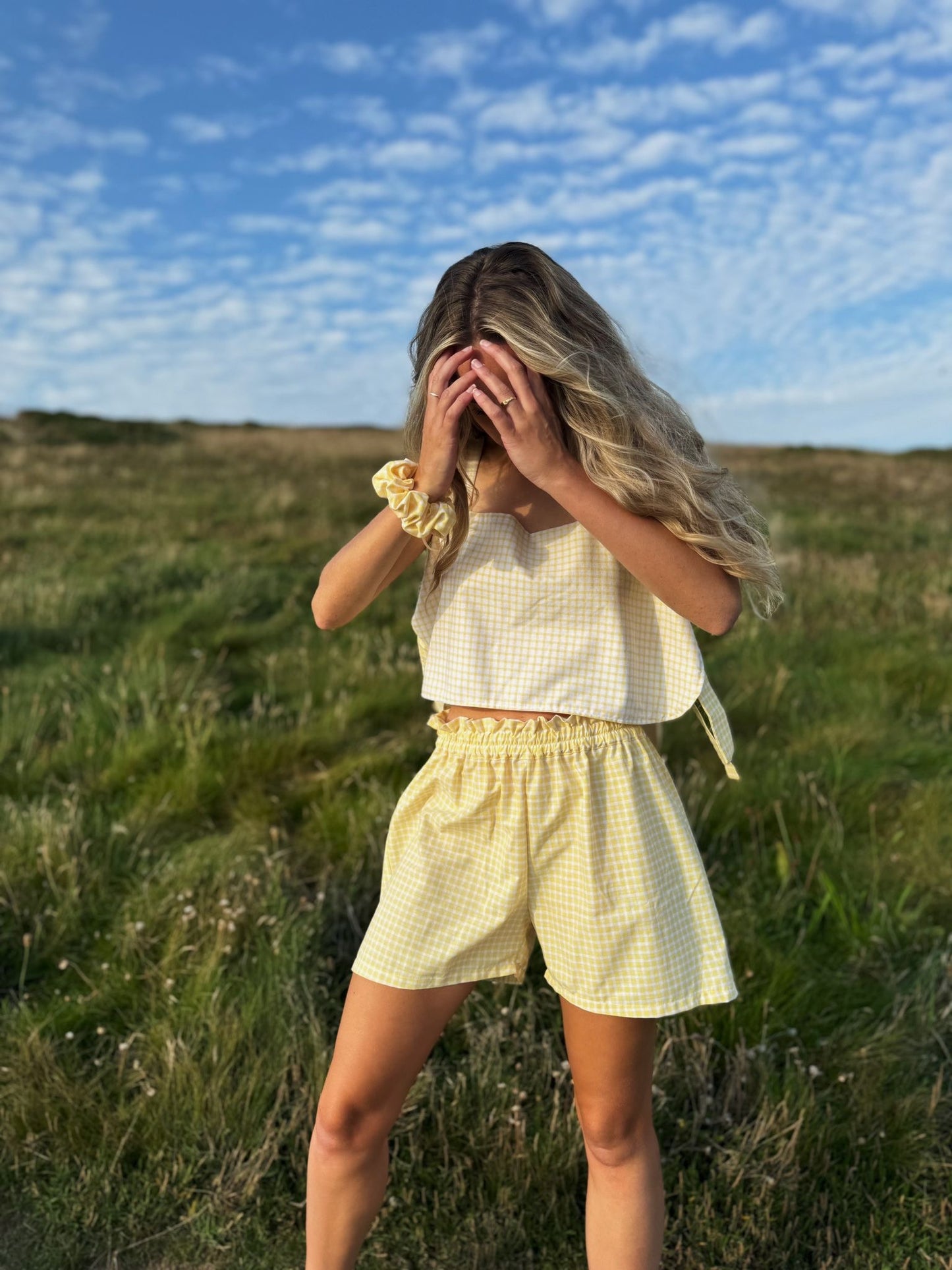 Model wearing yellow gingham Margot top made from repurposed fabric, sustainable summer style