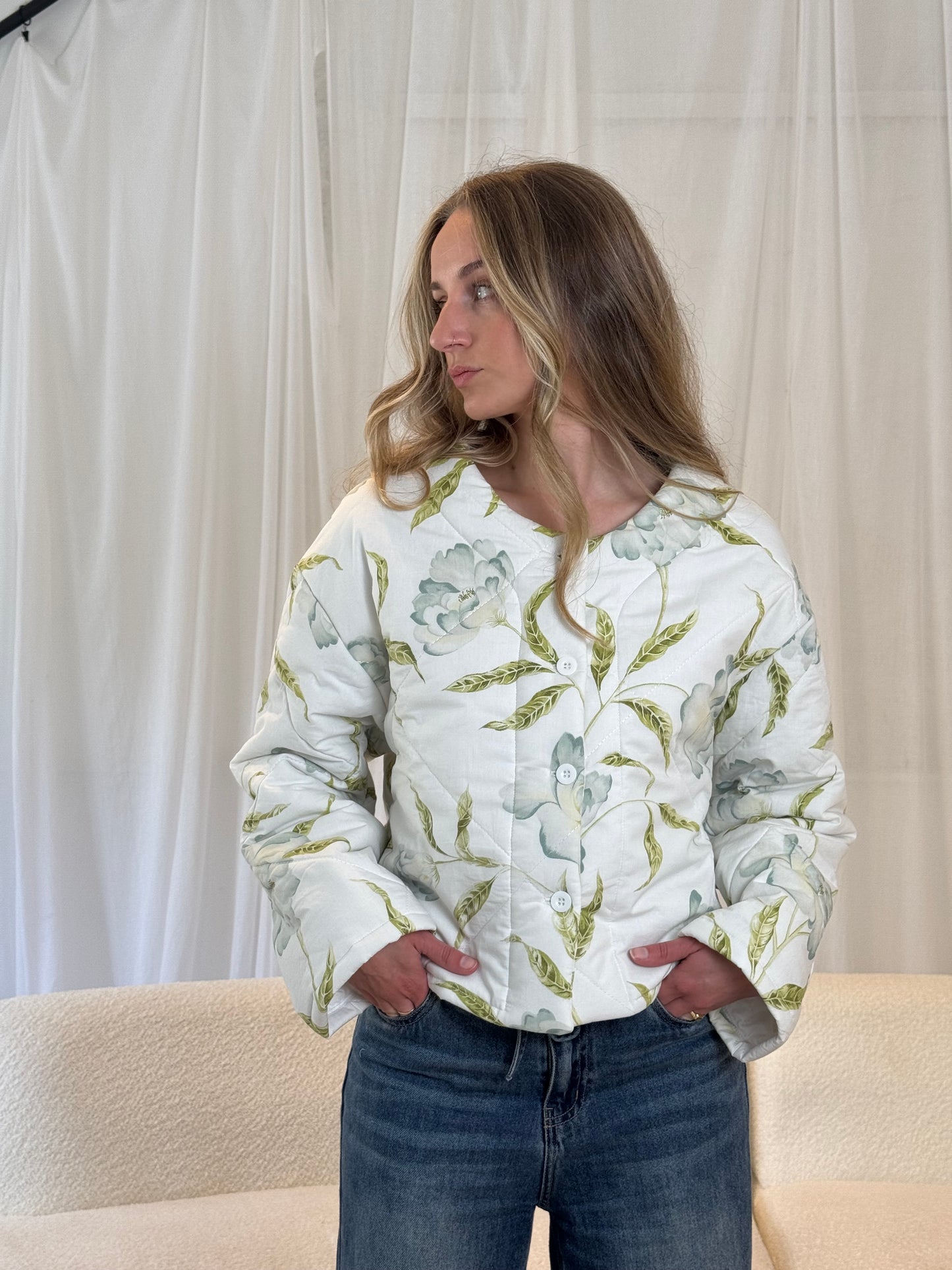 Woman wearing a repurposed floral quilted jacket, sustainable outerwear