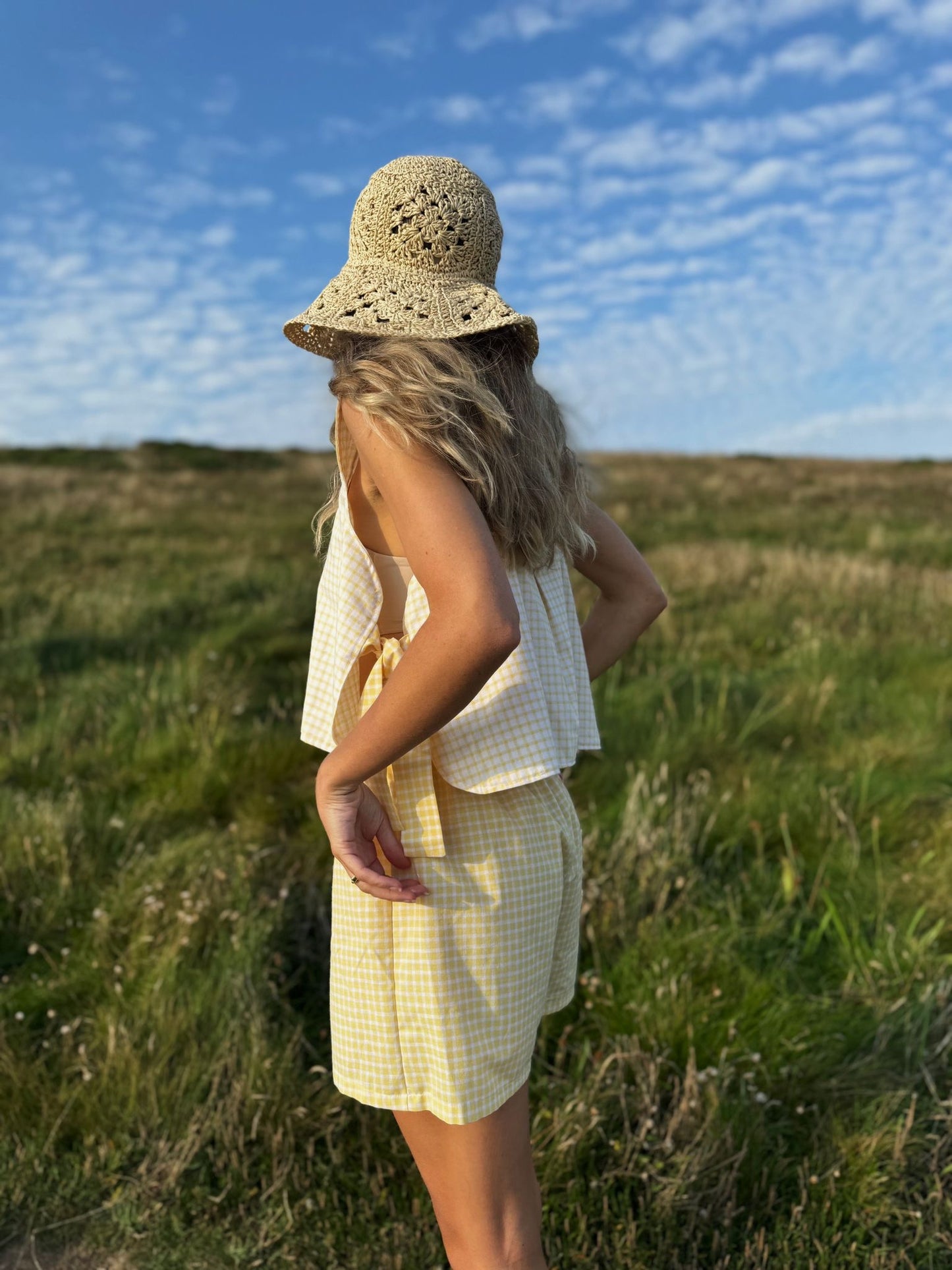 Model wearing yellow gingham Margot top made from repurposed fabric, sustainable summer style