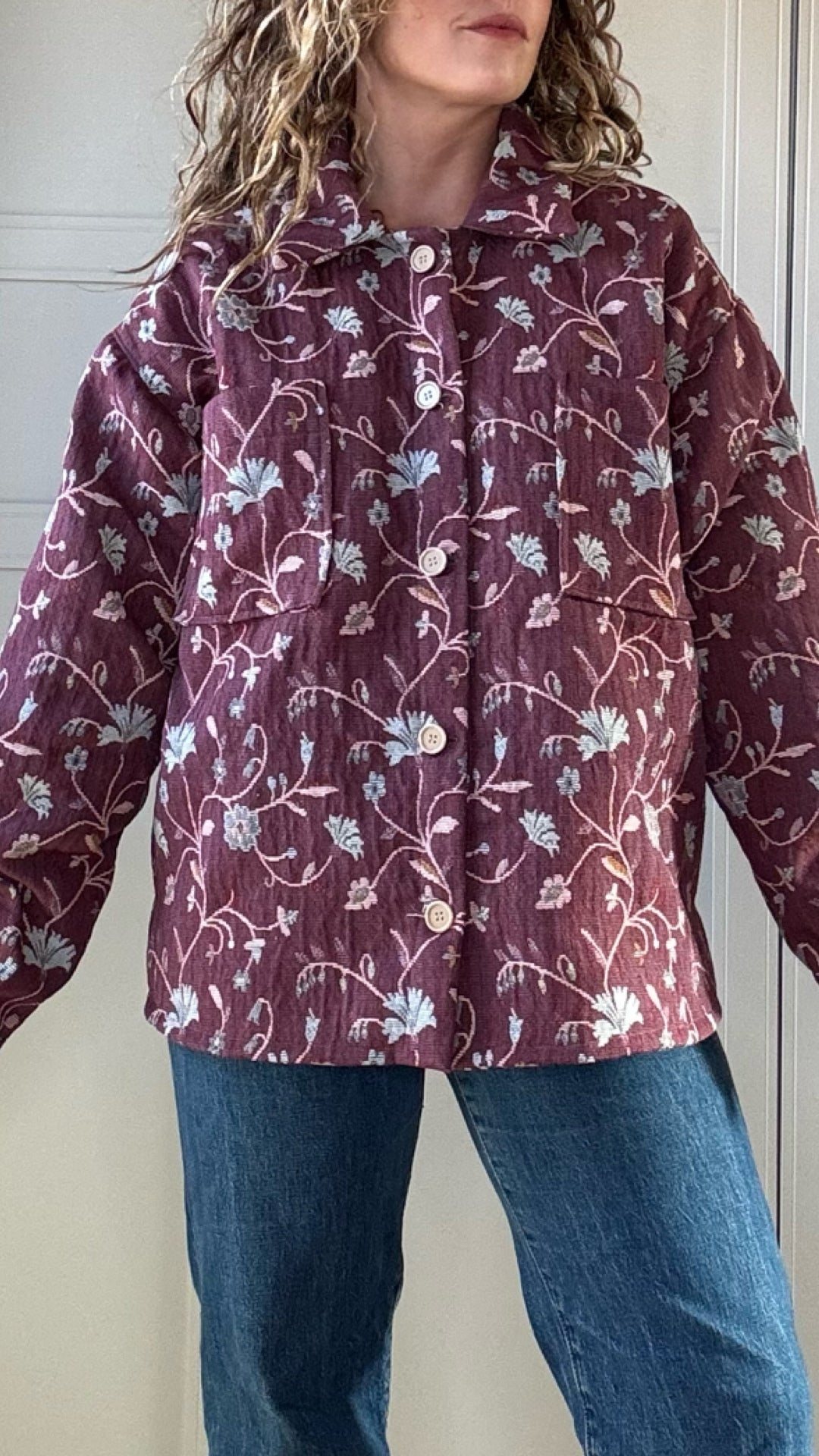 Woman wearing vintage floral jacket made from upcycled curtains, sustainable outerwear