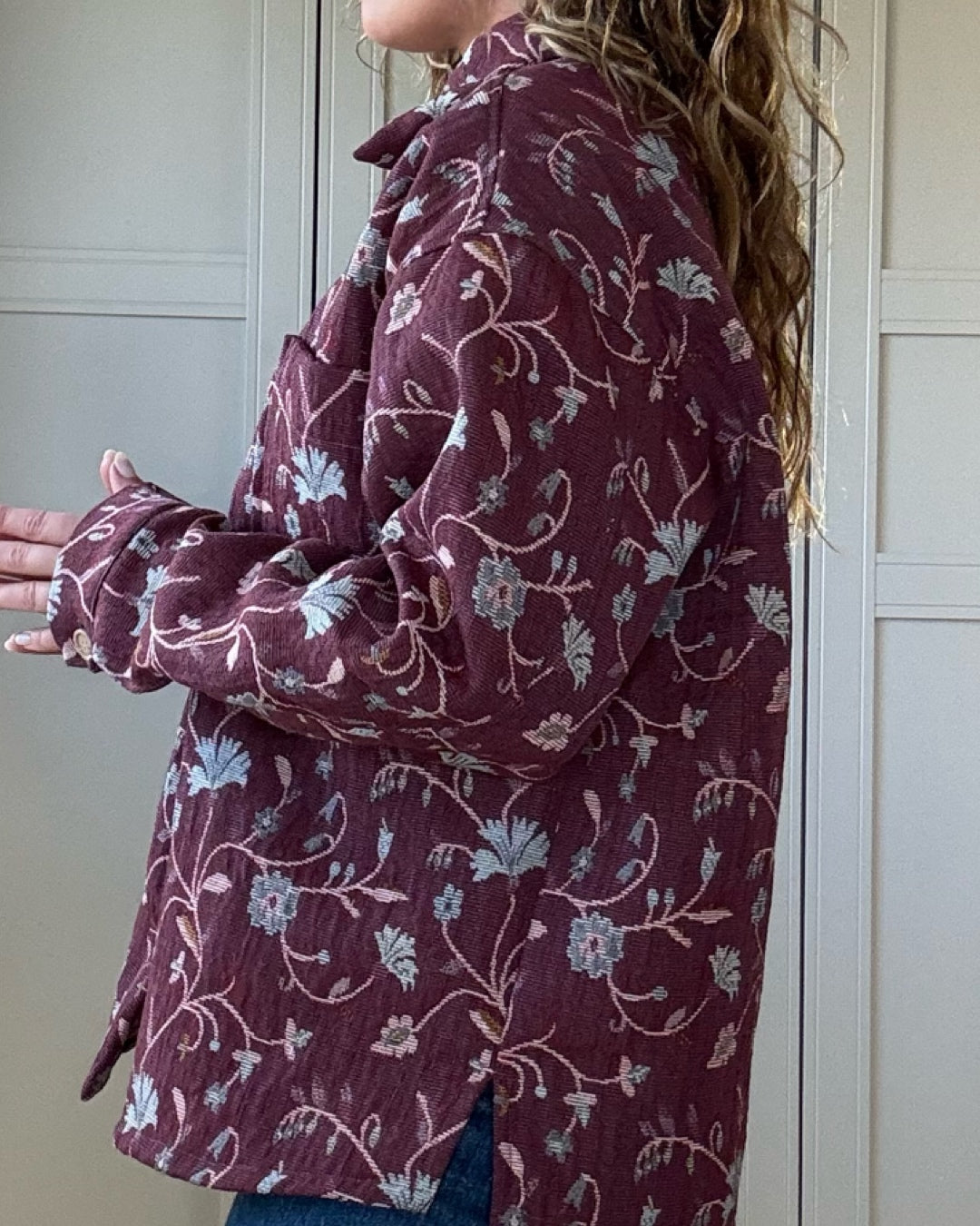 Woman wearing vintage floral jacket made from upcycled curtains, sustainable outerwear