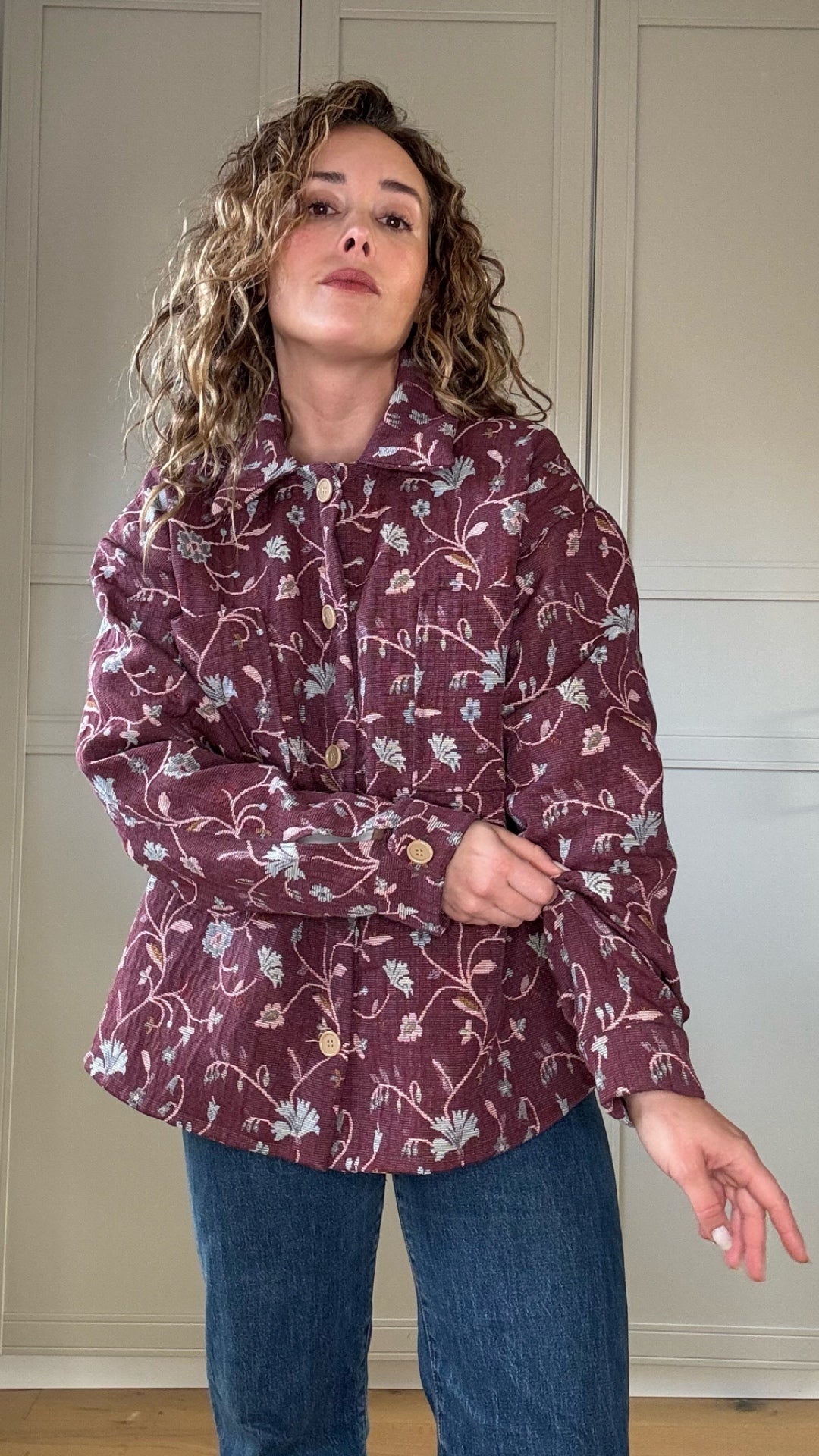 Woman wearing vintage floral jacket made from upcycled curtains, sustainable outerwear