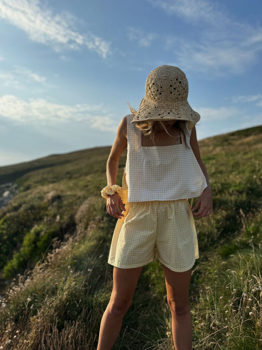 Model wearing yellow gingham Margot top made from repurposed fabric, sustainable summer style