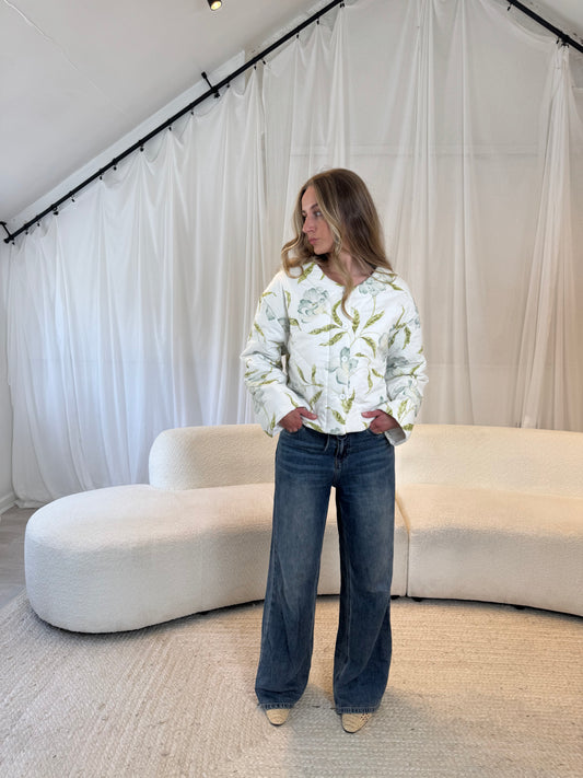 Woman wearing a repurposed floral quilted jacket, sustainable outerwear

