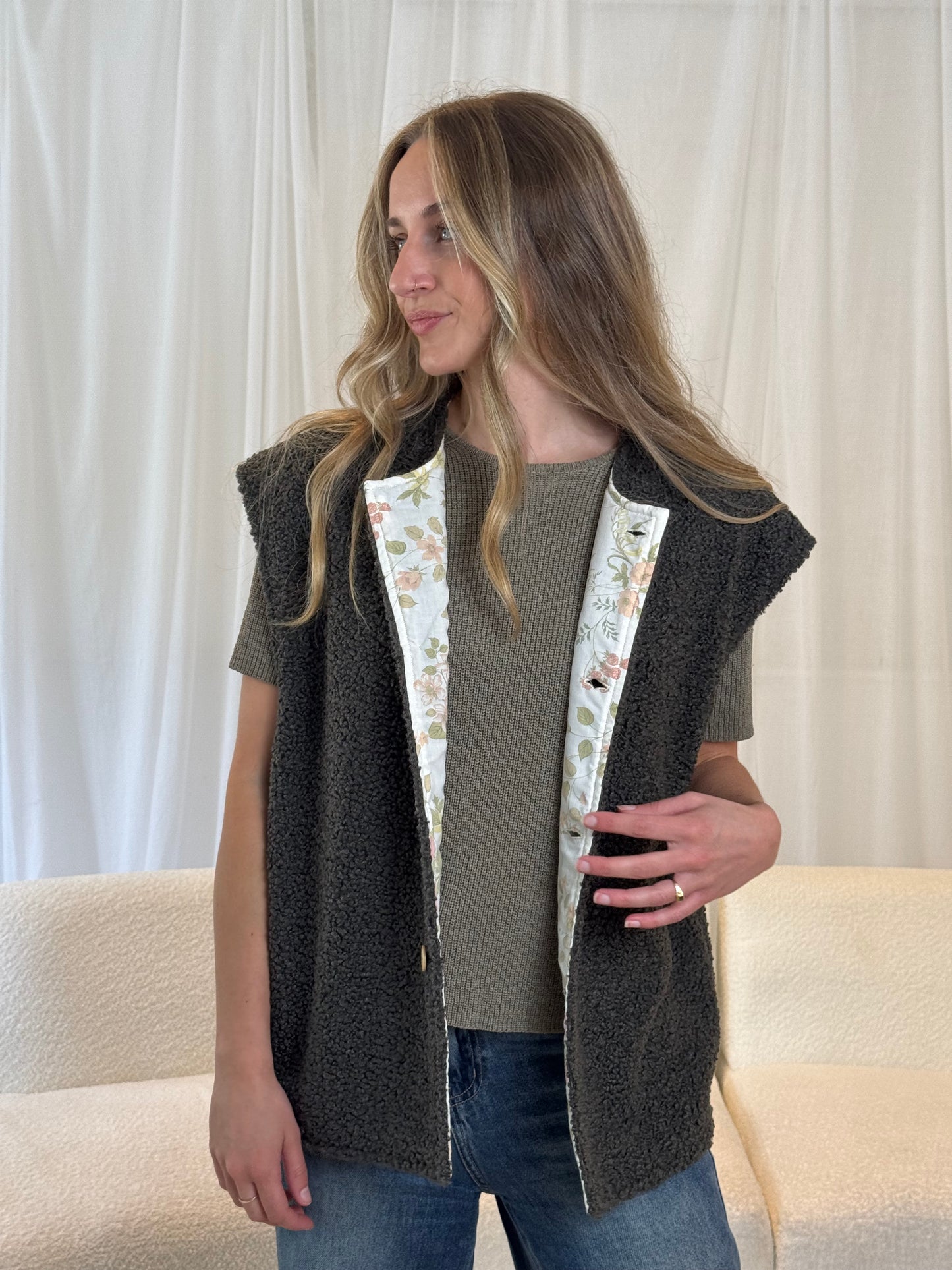 Model in dark grey sustainable gilet vest made from repurposed materials
