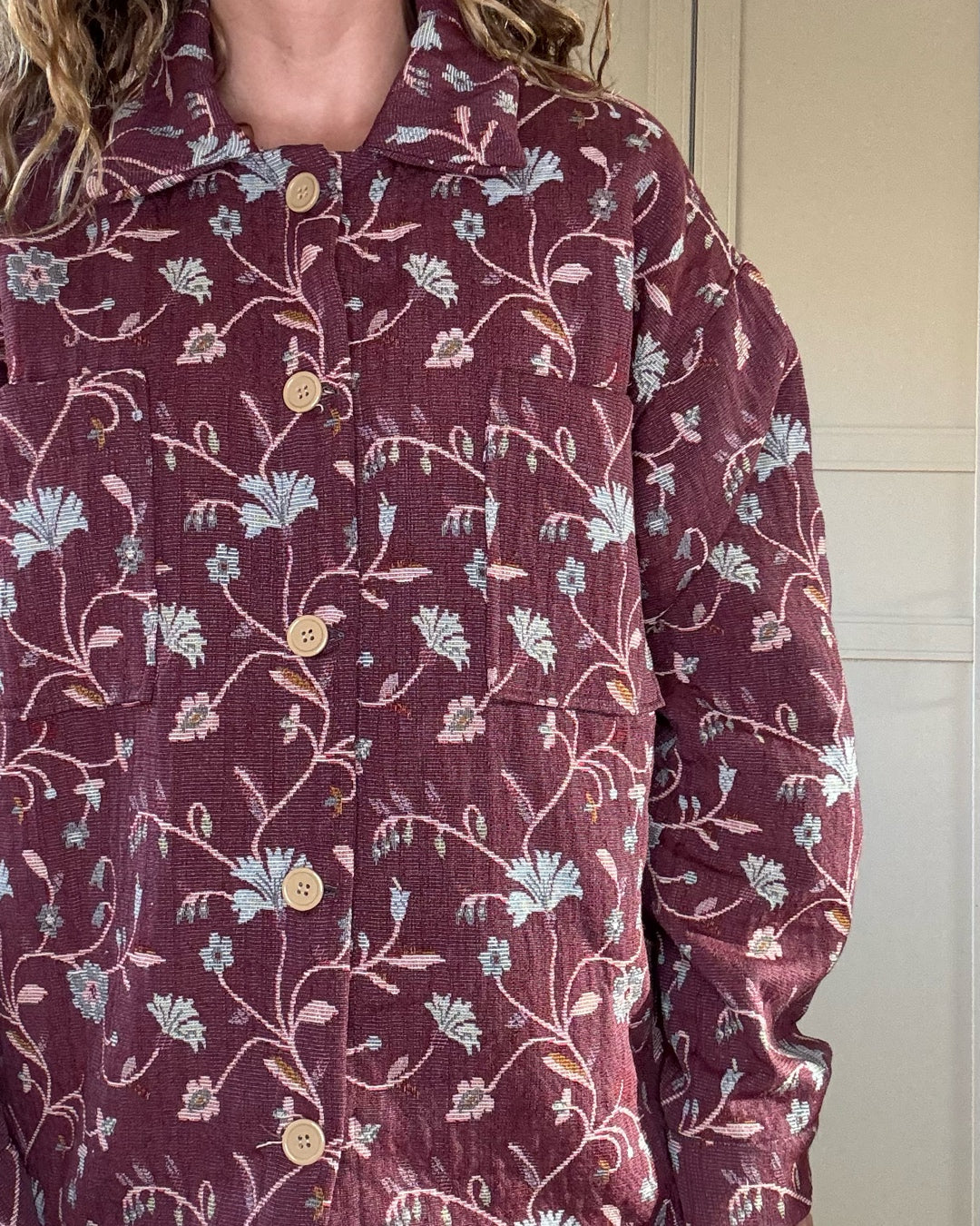 Woman wearing vintage floral jacket made from upcycled curtains, sustainable outerwear