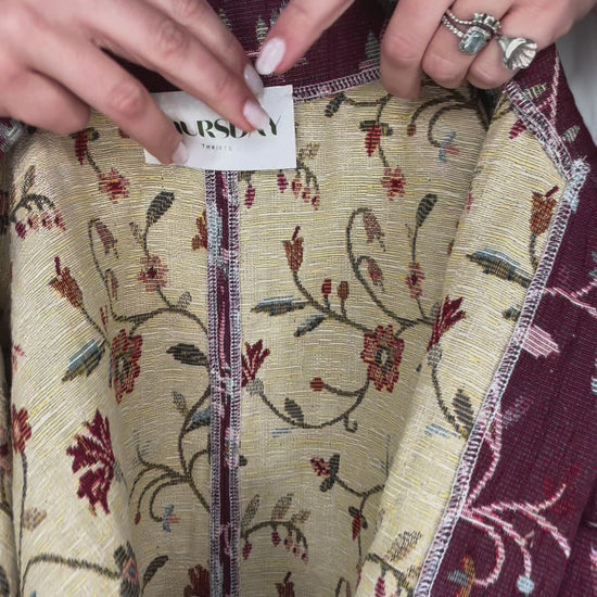 Woman wearing vintage floral jacket made from upcycled curtains, sustainable outerwear