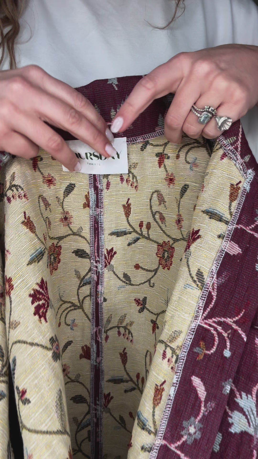 Woman wearing vintage floral jacket made from upcycled curtains, sustainable outerwear